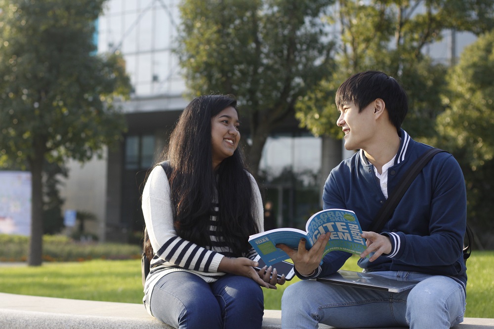 two students reading a book